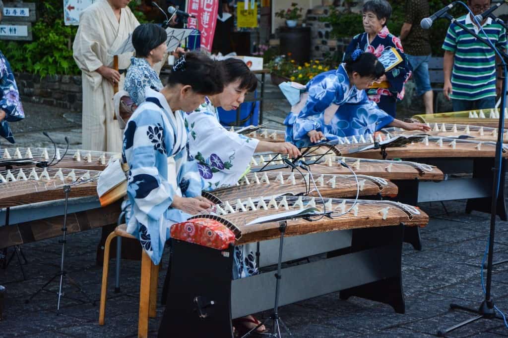 playing traditional Japanese instrument in Japan