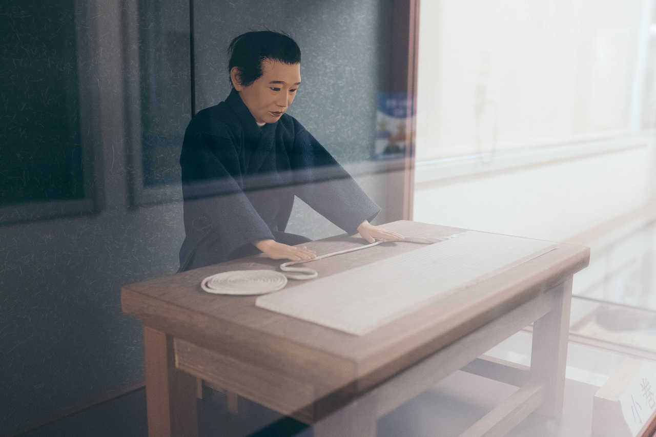 small model showing man making japanese udon