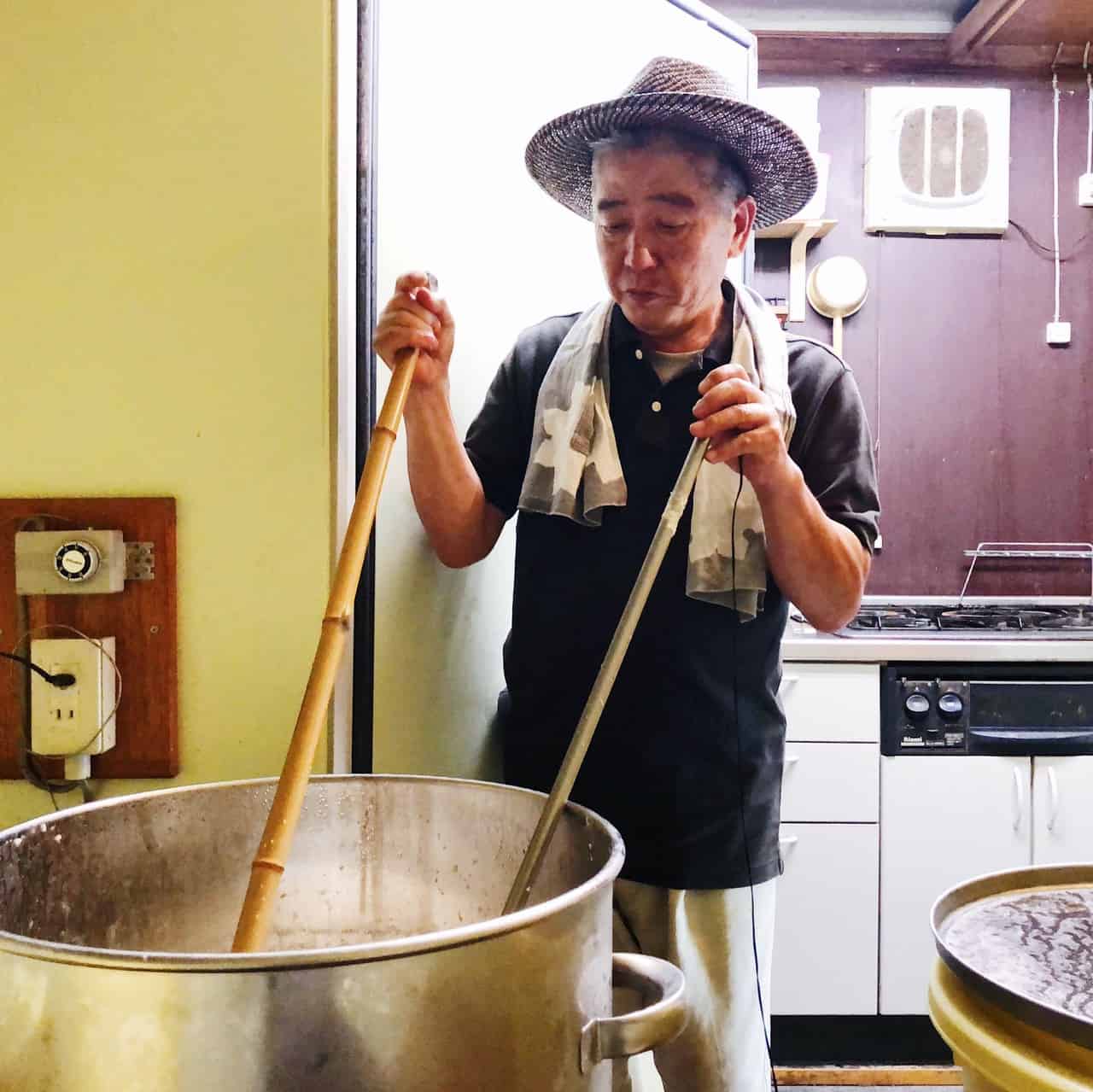 The craftsman stirring the doburoku during fermentation