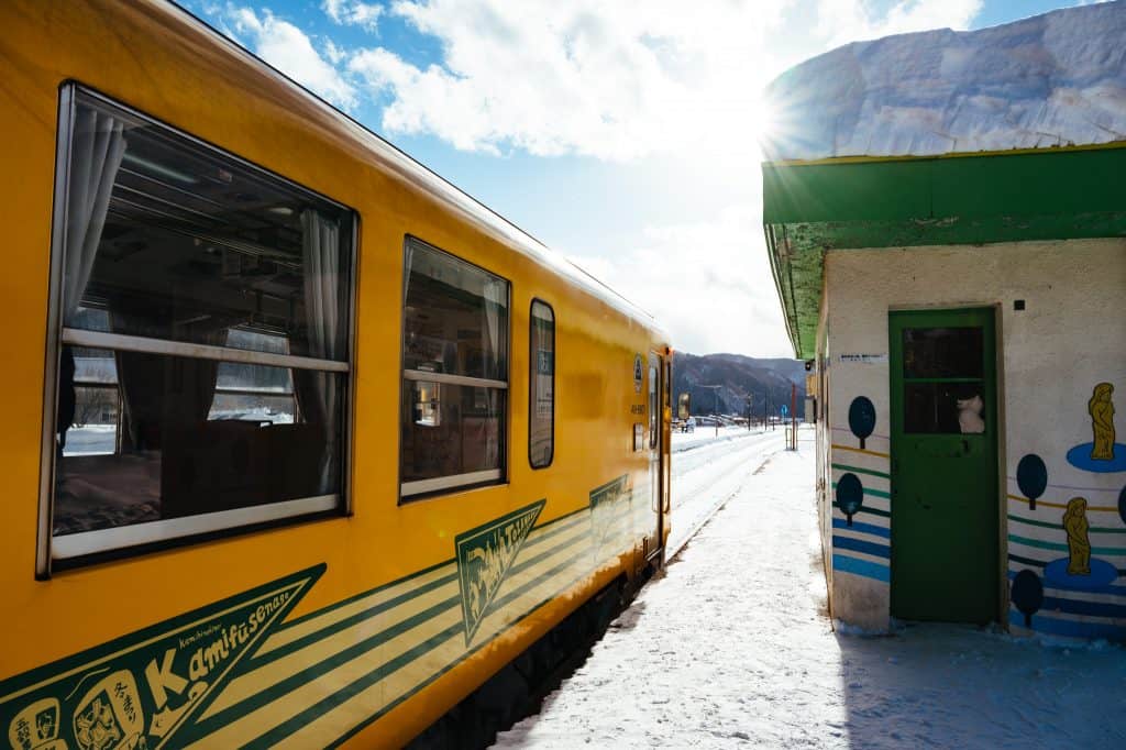 Akita Nairiku Train stops at a snowy station in Akita Prefecture.
