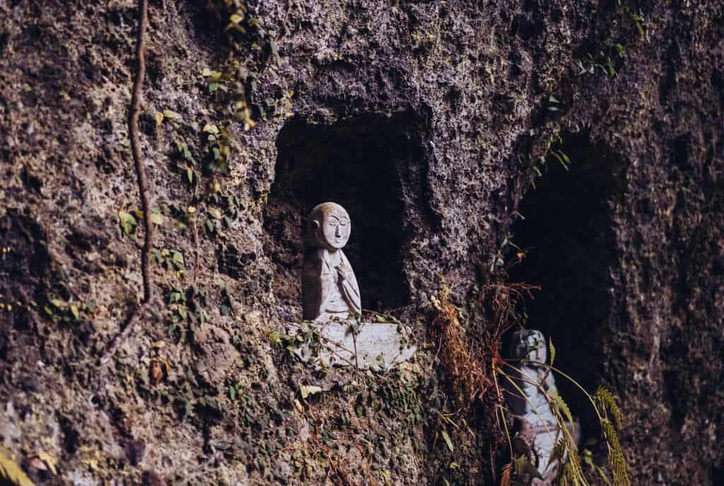 Japanese Buddhist statue in side of cliff in Oita prefecture
