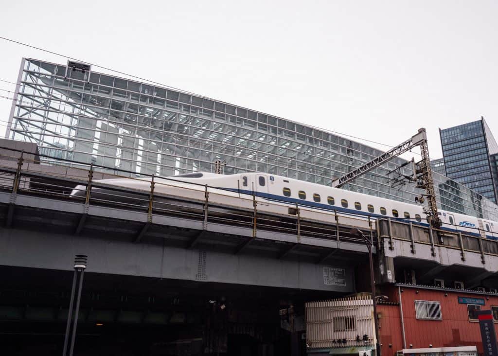Shinkansen passing in front of Tokyo International Forum building