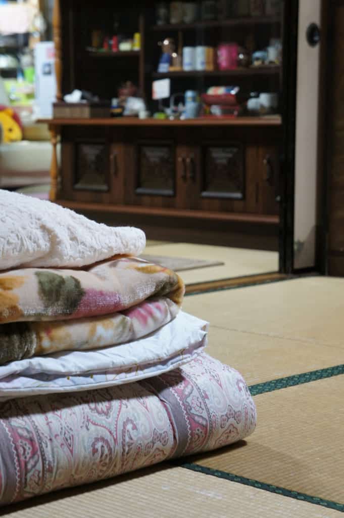 Futon and sheets prepared and folded in the tatami room
