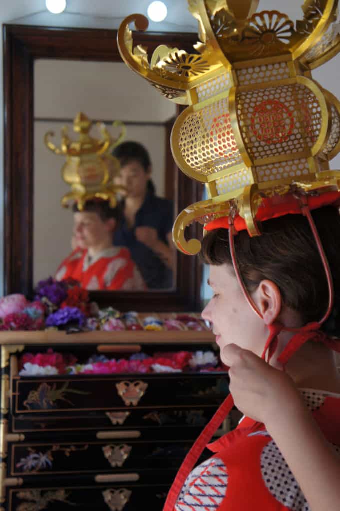 Risa adjusting a Yamaga lantern on Clémentine's head
