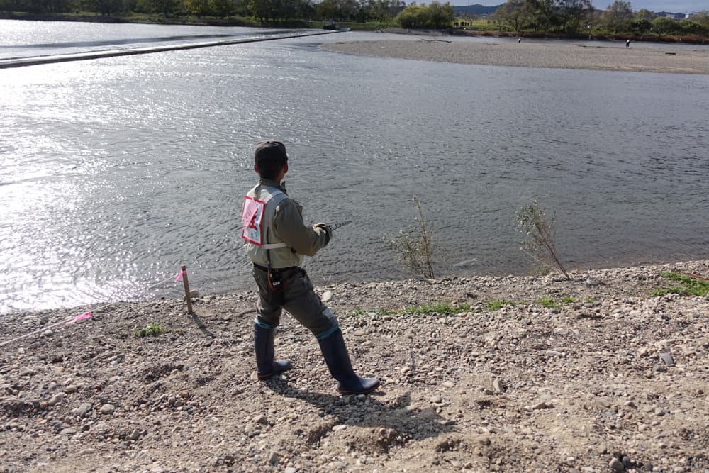 A fisherman catching salmon in Murakami. 