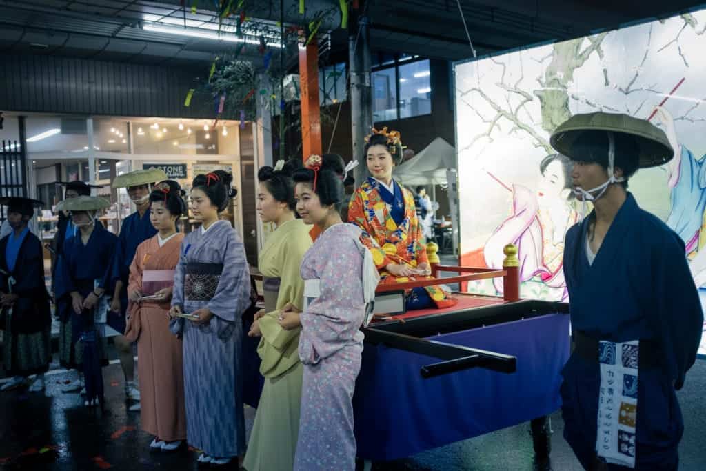 Women in kimono pose during the Tanabata festival parade in Yuzawa