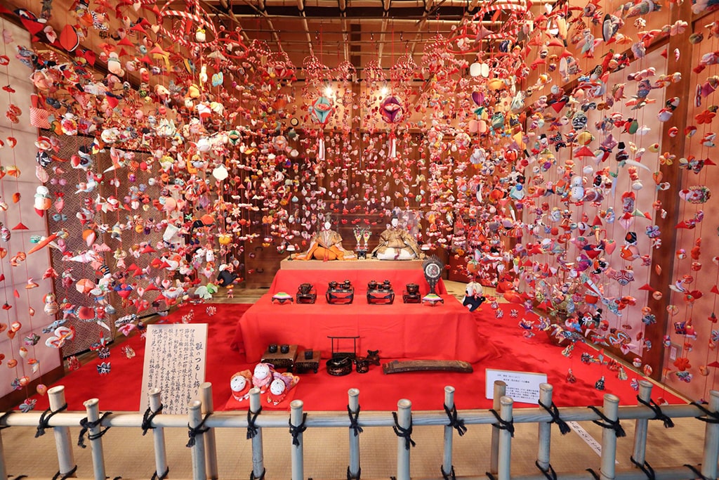 Couple of Hina dolls surrounded by fabric decorations