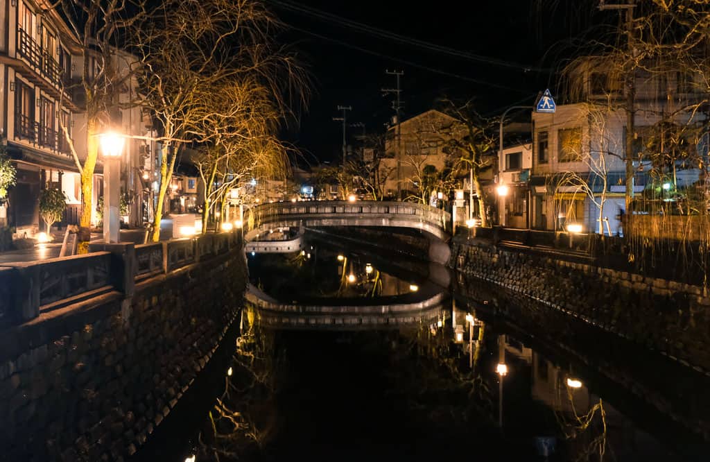 Traditional Japanese night time view of canals at Kinosaki Onsen town in Japan