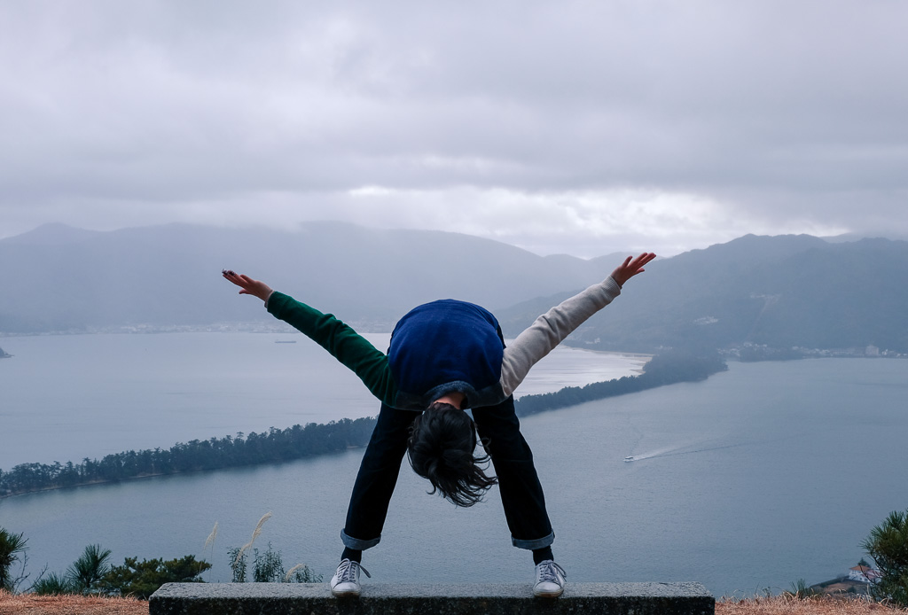 Participating in the upside down tradition of viewing Amanohashidate, one of the top three scenic sights in Japan