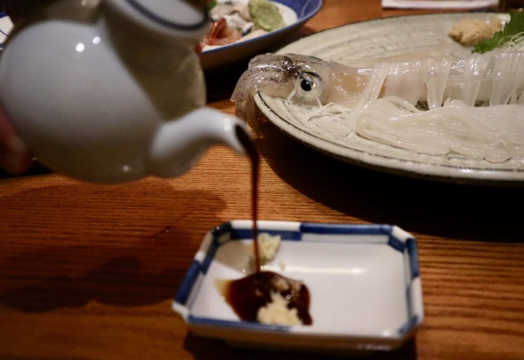 Fresh squid served with soy sauce and grated ginger