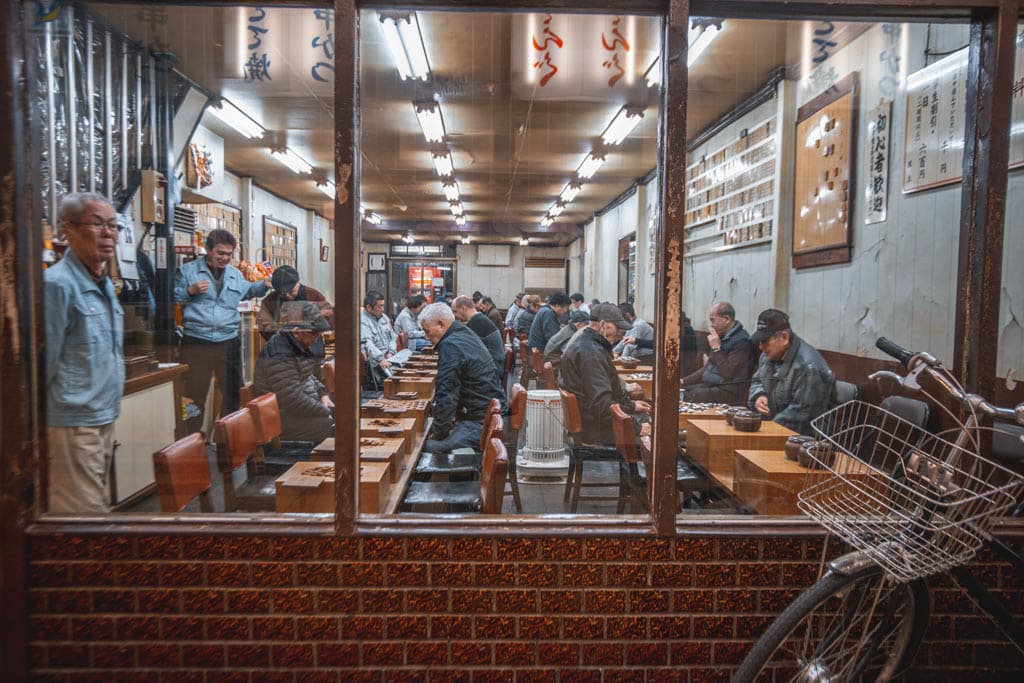 Japanese people playing old-fashioned board games in Shinsekai, Osaka