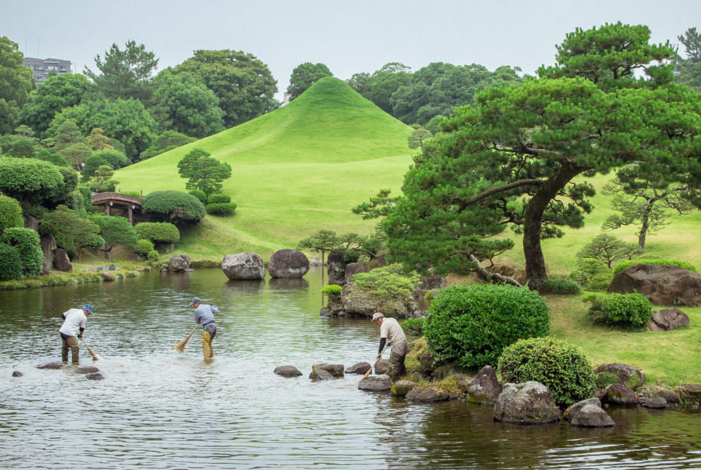 Workers tending to Suizenji Park