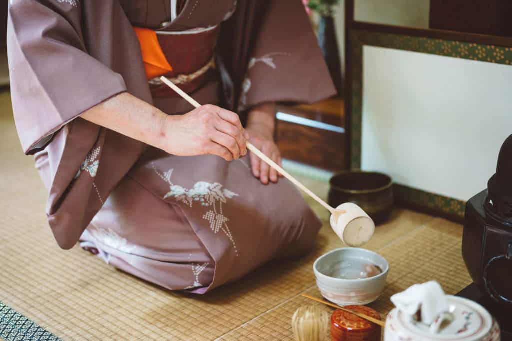 pouring hot water into the tea bowl during tea ceremony