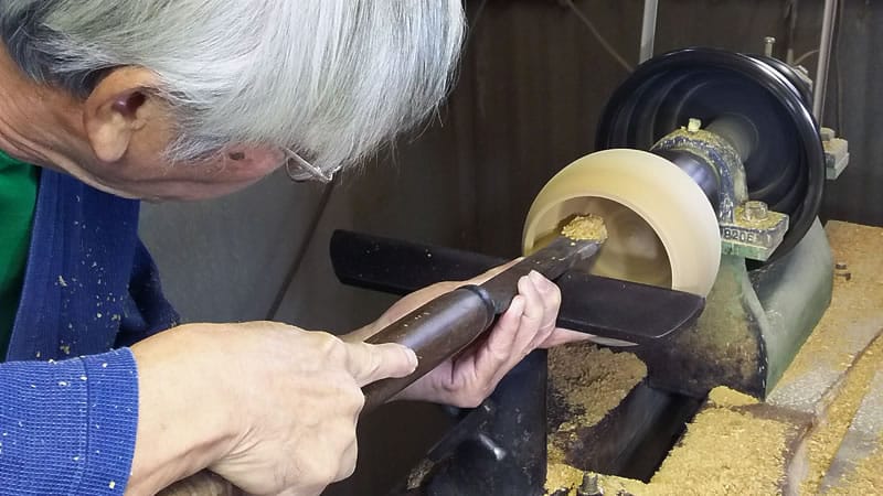 japanese craftsman making a traditional go bowl