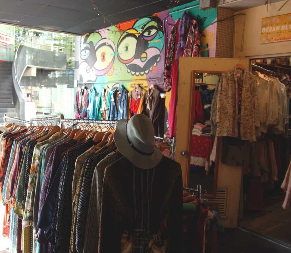 rails of clothing inside a thrift store in Shimokitazawa