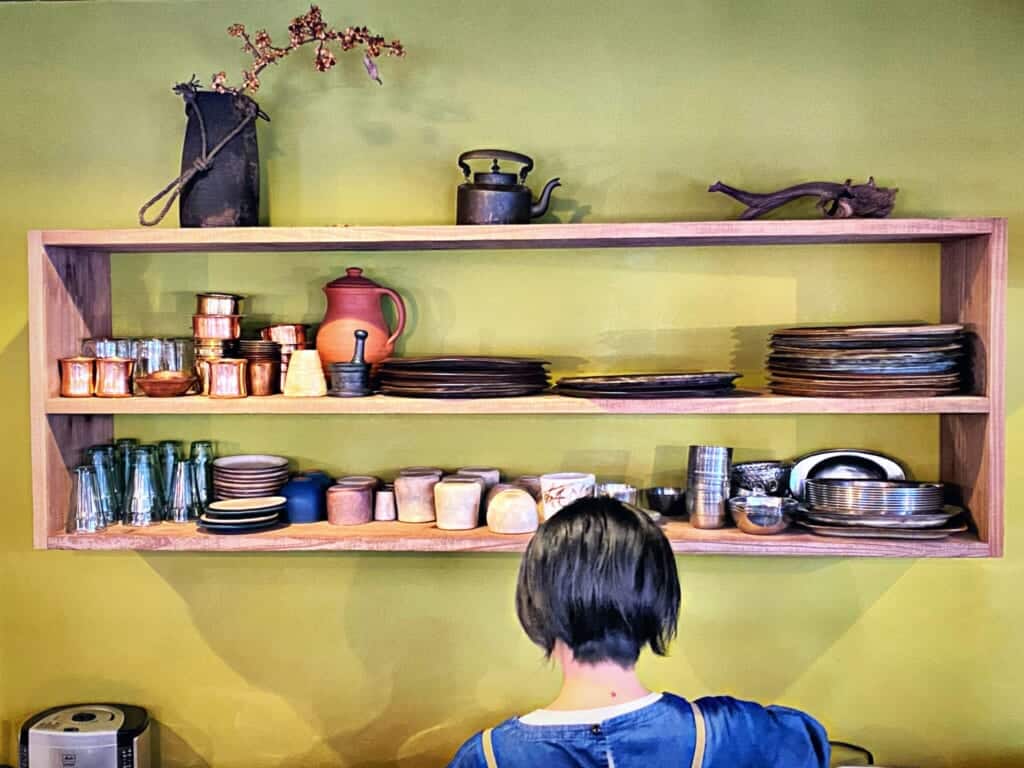 In the kitchen: tableware on a wooden shelf