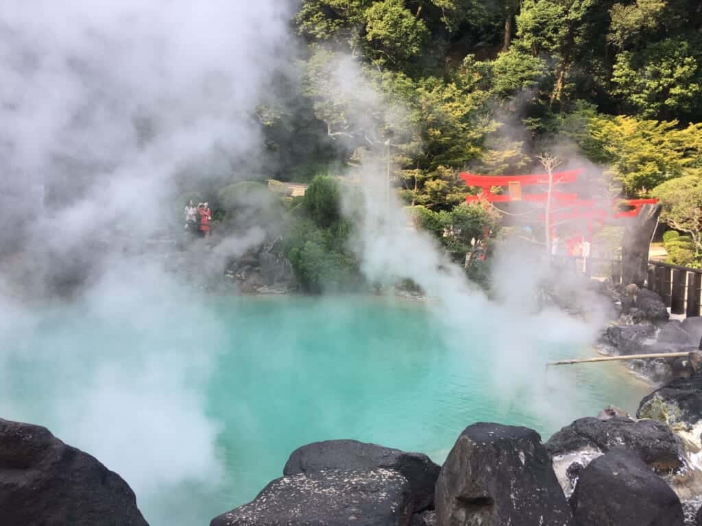 The blue water and red torii of the Umi Jigoku in Beppu