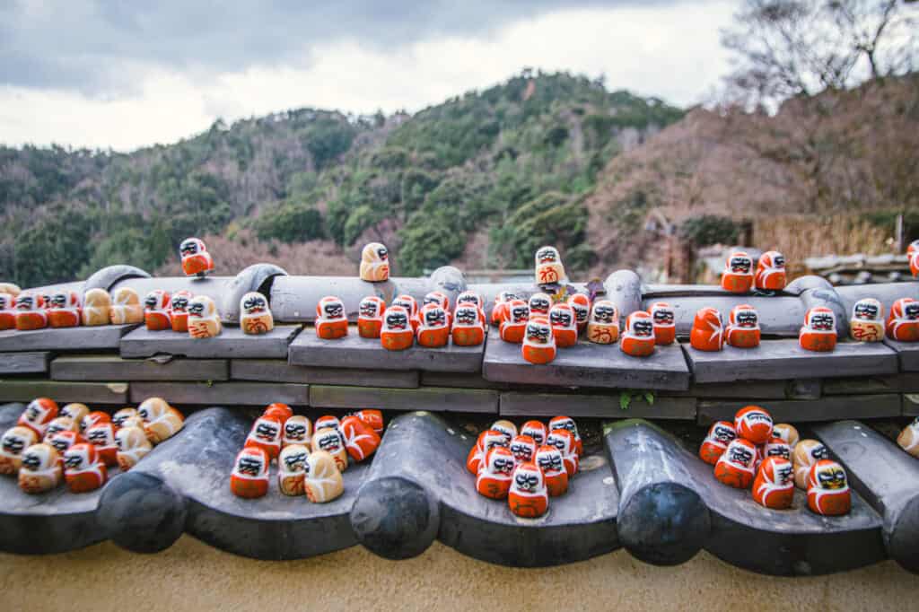 dozens of small daruma on a roof