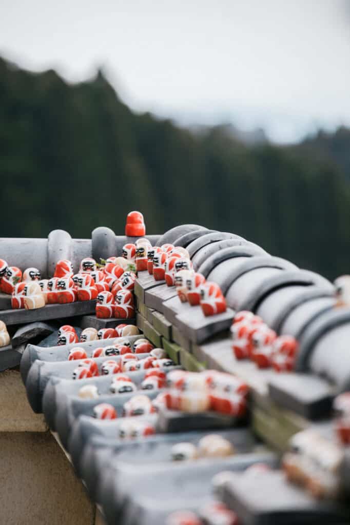 dozens of small daruma on a roof in Katsuo ji temple