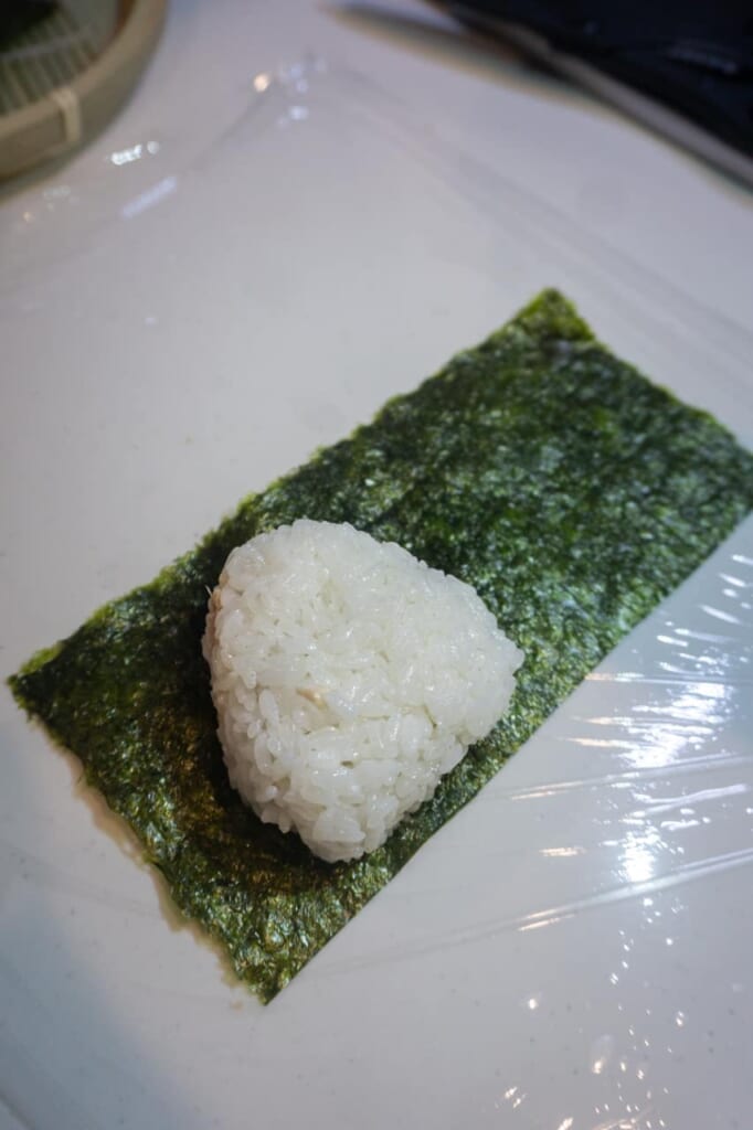 Starting to wrap the onigiri