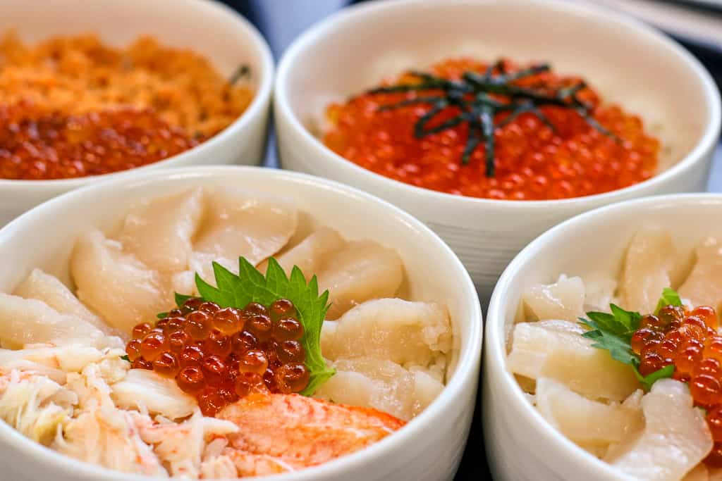 A crab, scallop, and salmon bowl donburi.