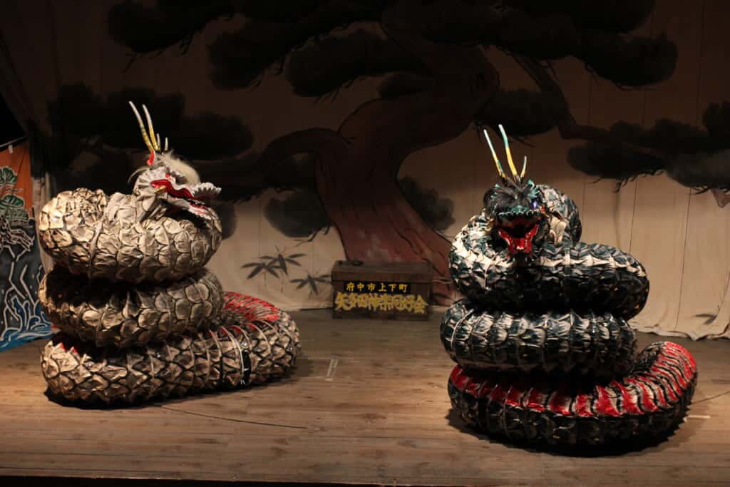 Japanese kagura theater dragons on a wooden stage 