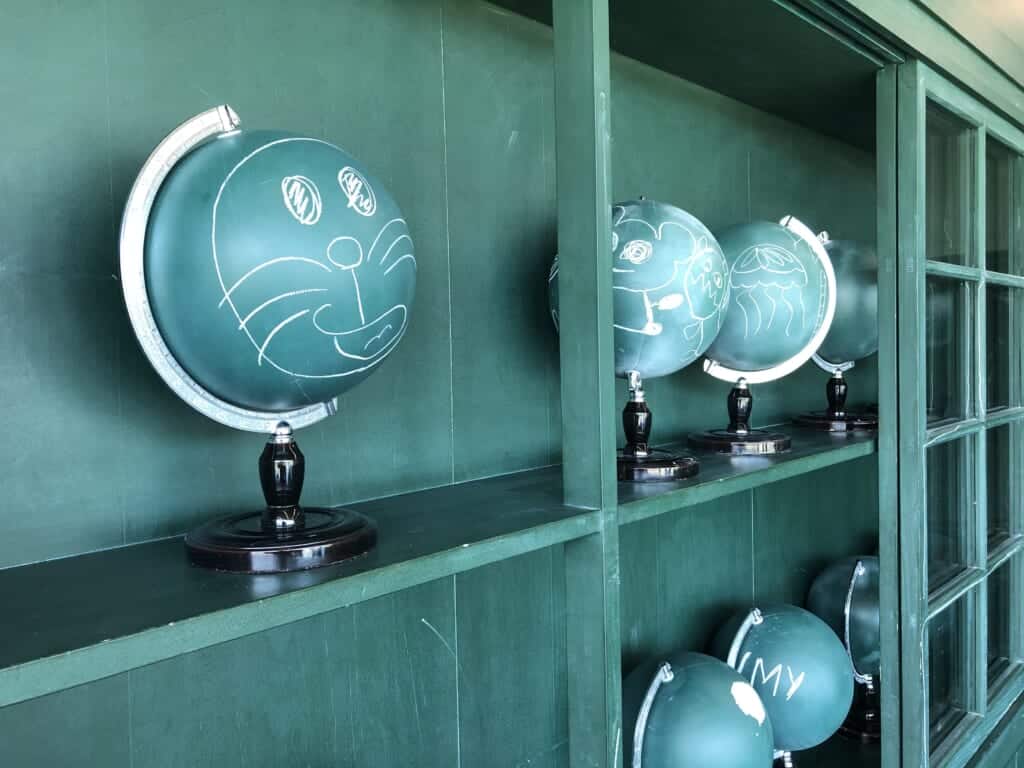 Blue globes with Doraemon's face drawn with white chalk 