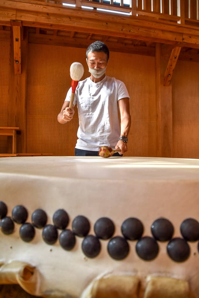 Masked man beating taiko on Sado Island in Niigata
