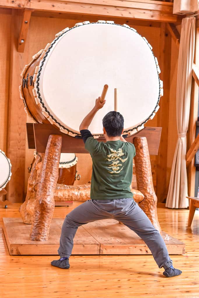 Man beating drum on taiko on Sado Island in Niigata