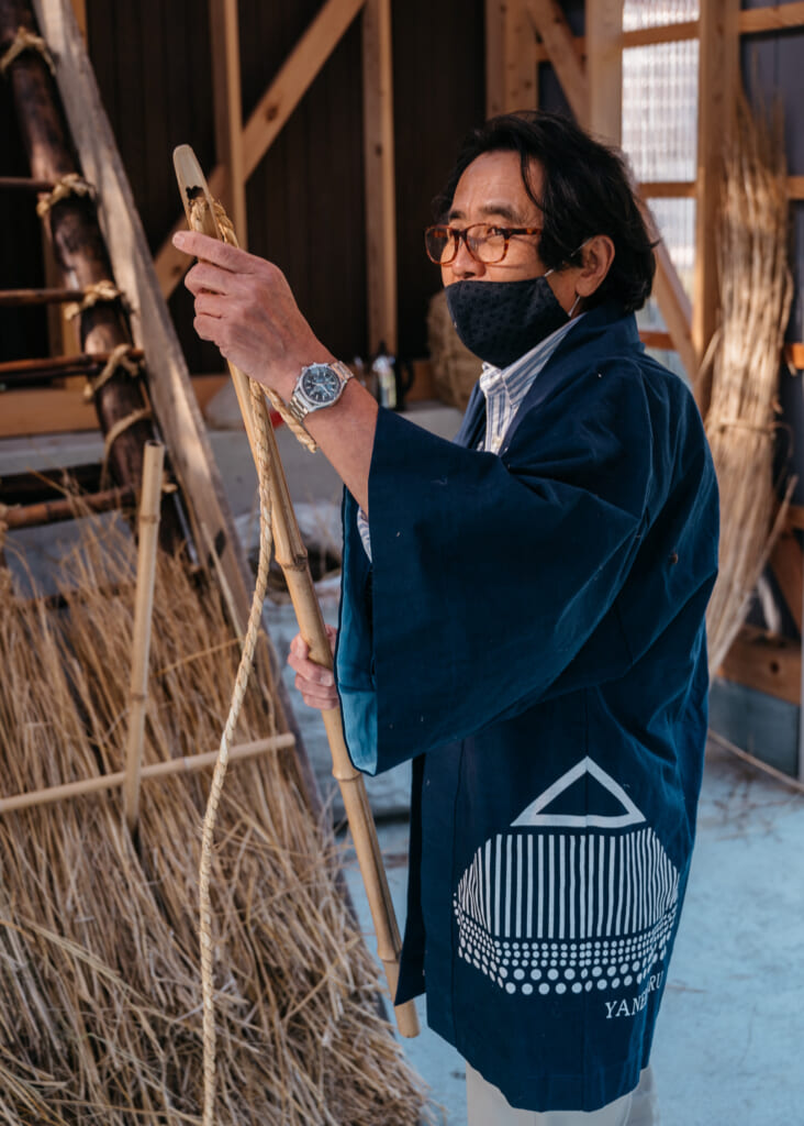 learning how to make traditional japanese thatched roof house in japan near kyoto