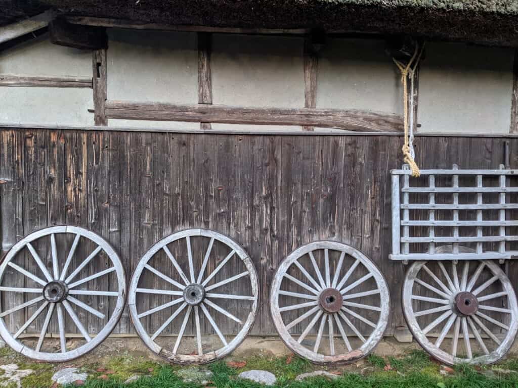 Northern Culture Museum wagon wheels arranged aside an old Japanese house