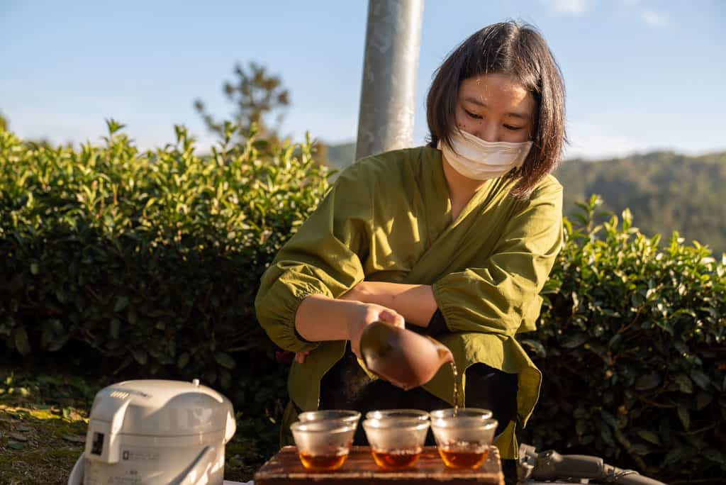 woman pours locally sourced green tea at Kyoto Obubu Tea Farms, Wazuka