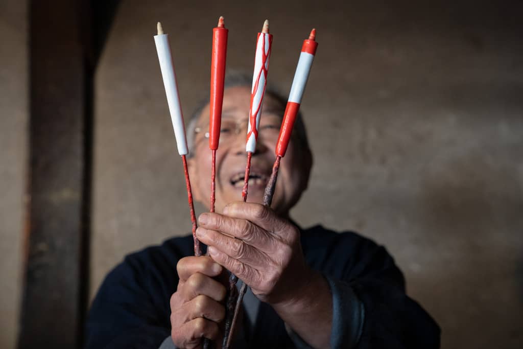 man holds up Traditional japanese candles in workshop in Gifu, Japan