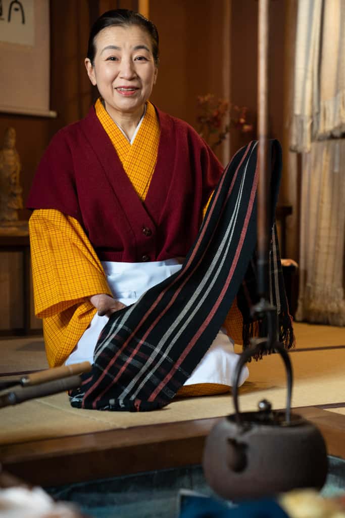 woman holds silk in gifu shop