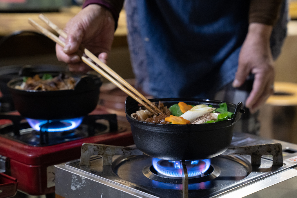 Stirring a pot of vegetables over the stove