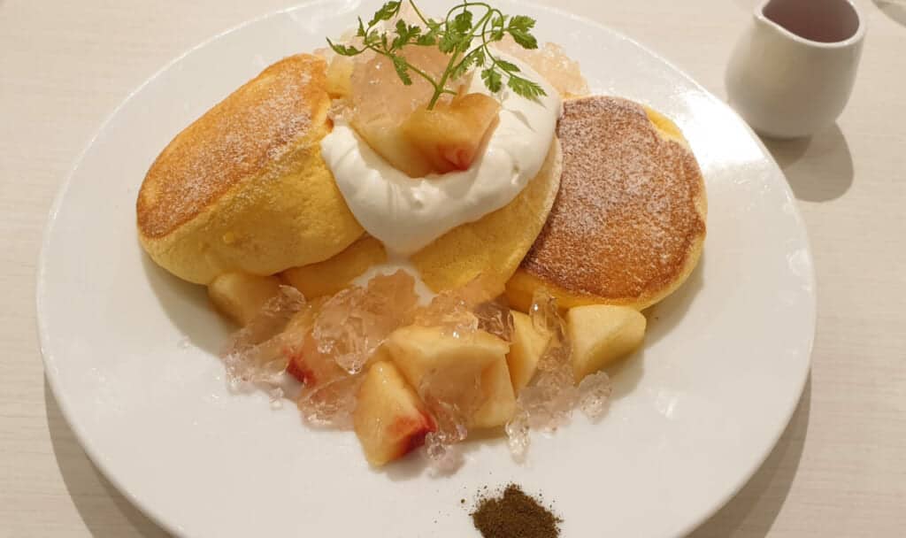 Japaneses fluffy pancakes with peach and jelly served in cafe in Japan