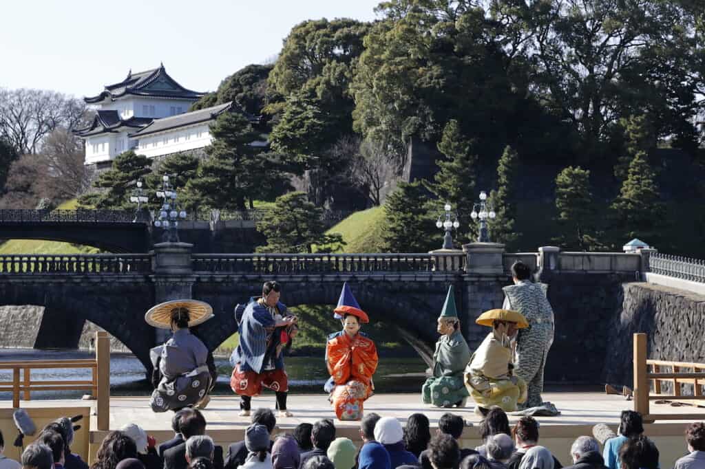 Traditional Japanese Kyogen Noh performers on stage in front of Imperial Palace in Japan