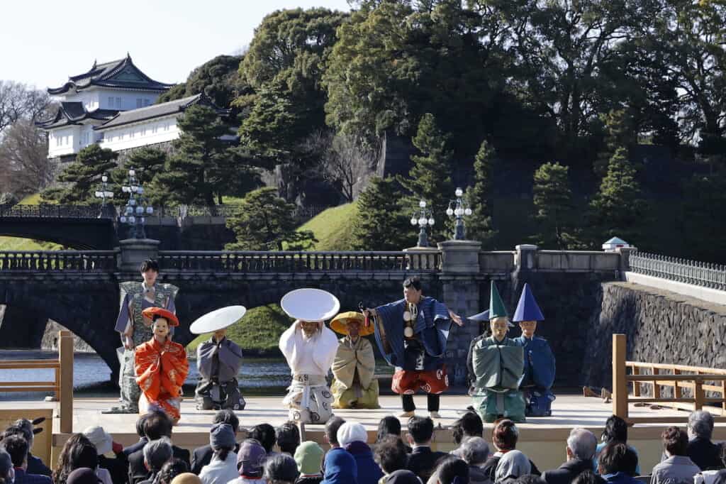 Traditional Japanese Kyogen  Noh performers on stage in front of Japan's Imperial Palace