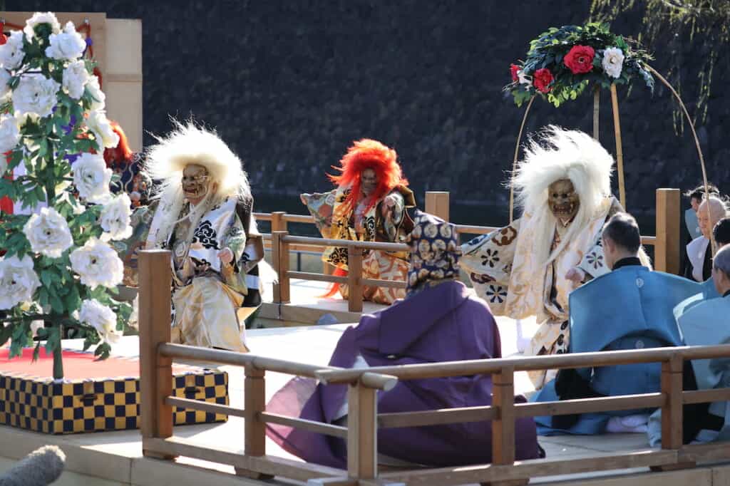 Traditional Japanese Noh lion dance performers on stage in Japan