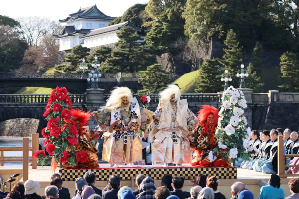 Traditional Japanese Noh dance where 2 white shishi and 2 red shishi on stage in front of Imperial Palace in Japan