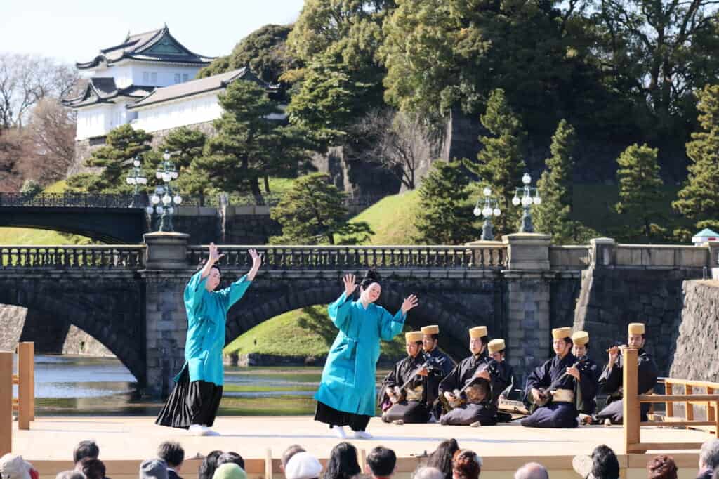 traditional Japanese dance with 2 Okinawan dancers in blue on stage in Japan