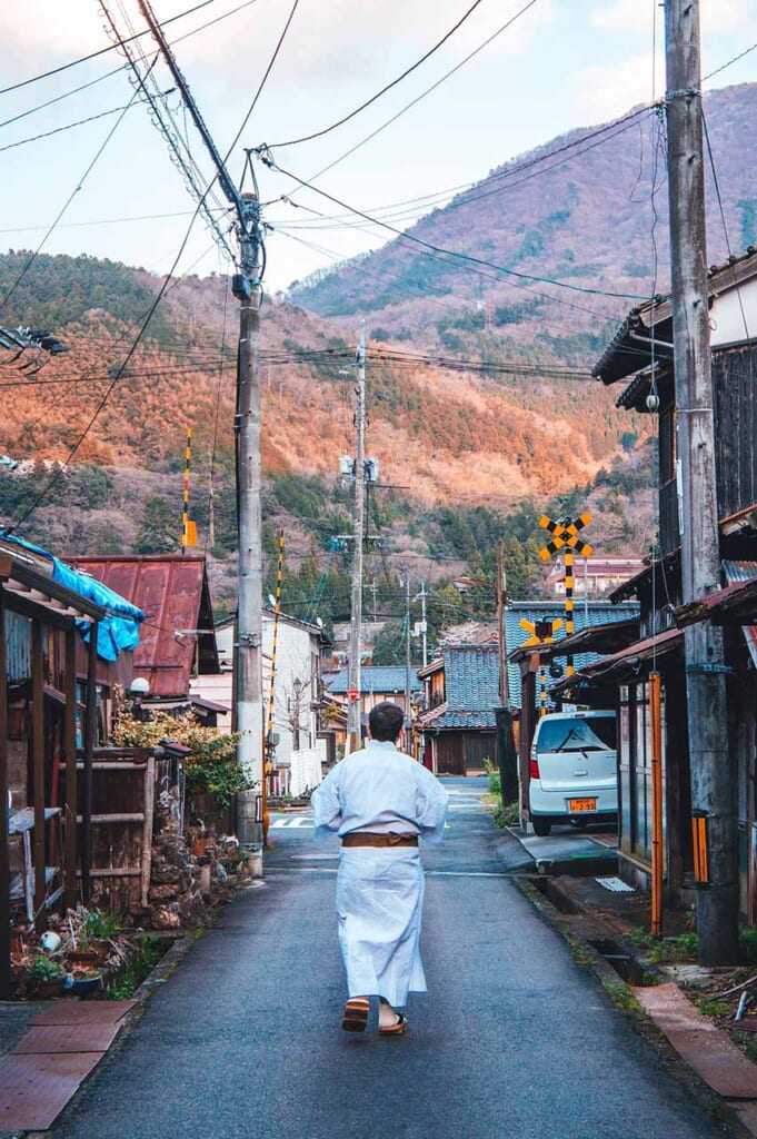 man wearing a yukata walking around the town
