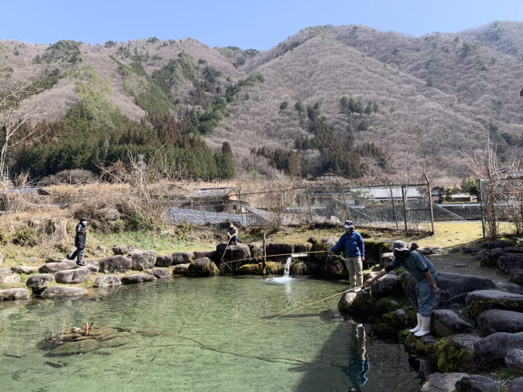 people fishing in a pond in Japan