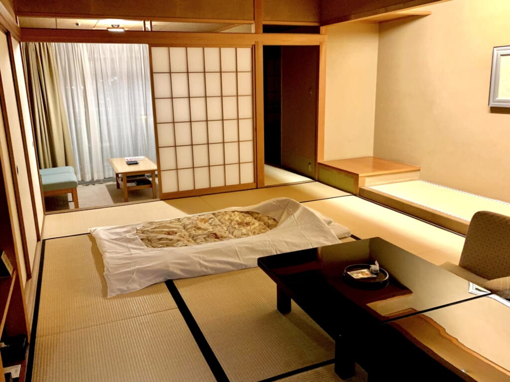 large tatami room with futon in traditional JApanese ryokan inn