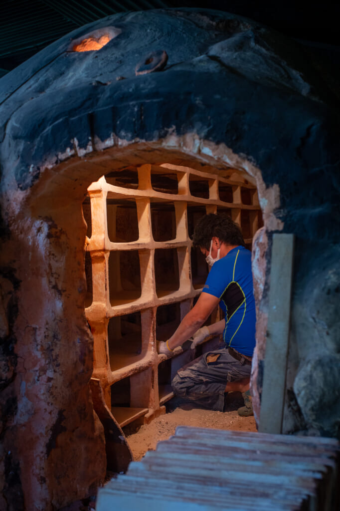a person working in a Japanese climbing kiln in Okinawa