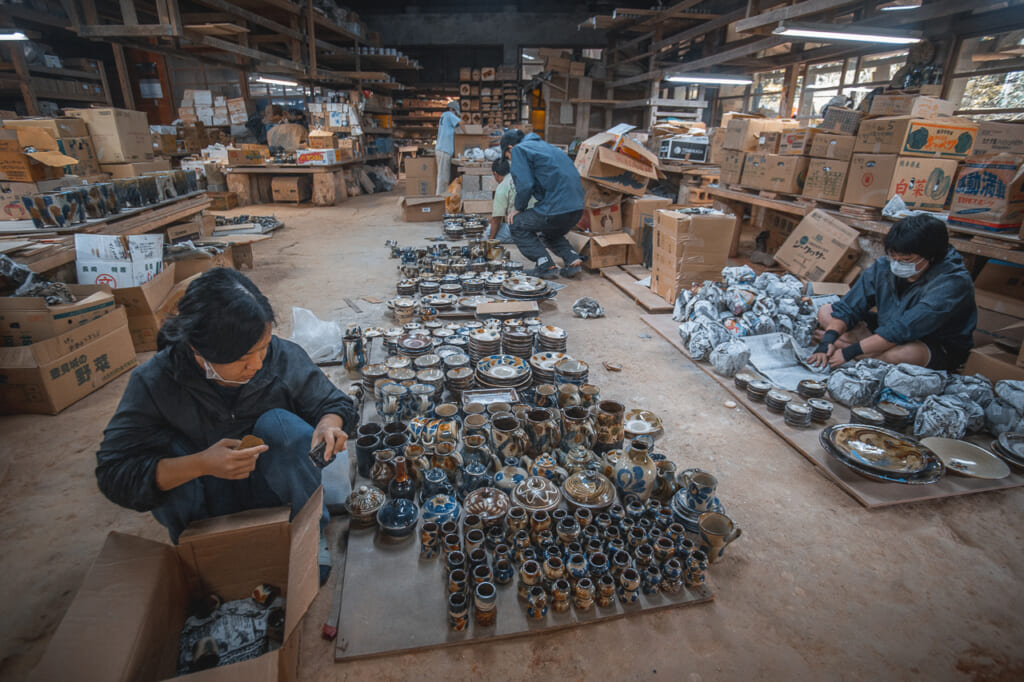 people working with japanese ceramics in matsuda workshop in okinawa
