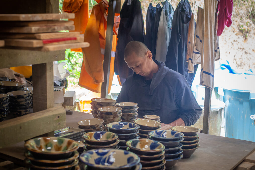 a man making japanese ceramics in okinawa