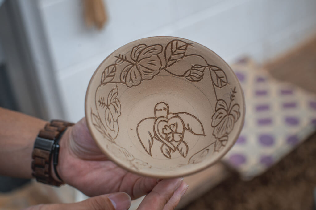 a smiling turtle carved in a bowl in Okinawa, Japan