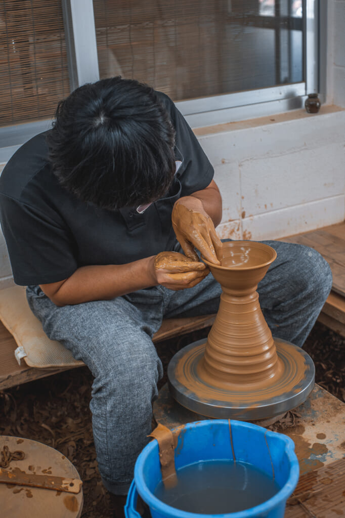 a Japanese craftsmen producing japanese pottery in Okinawa