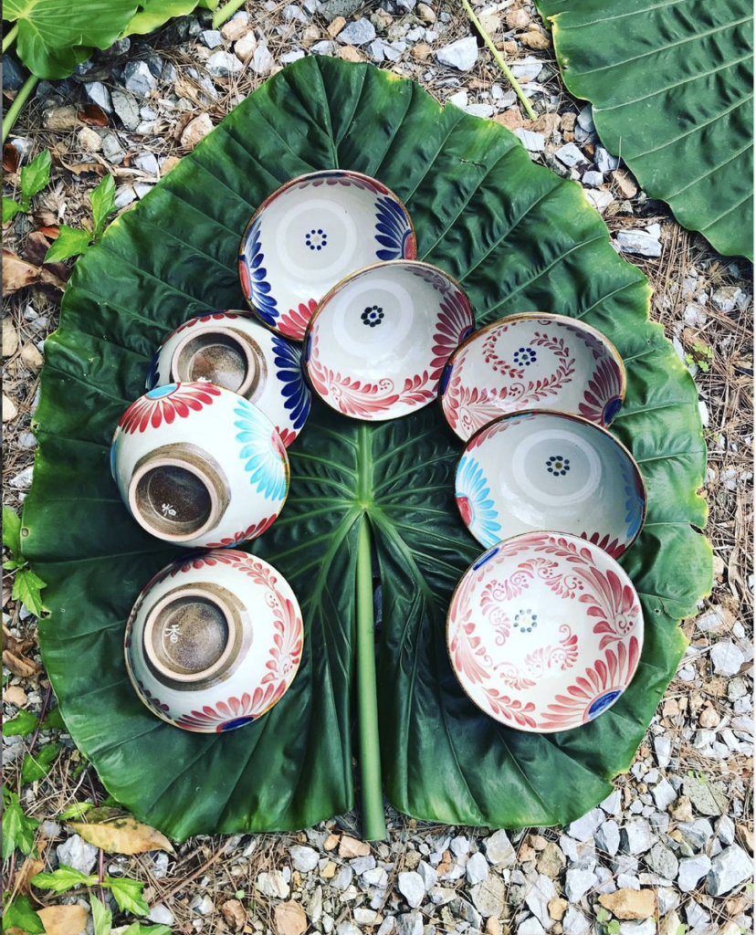 eight ceramic bowls on a big leaf in Okinawa, Japan